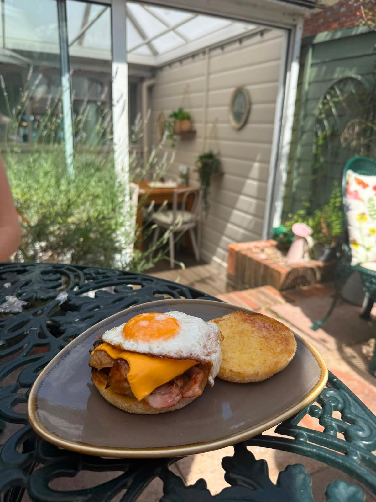Breakfast muffin with egg and cheese in the courtyard